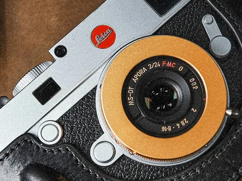 Leica M body with an orange MS-Optics Apoqualia lens