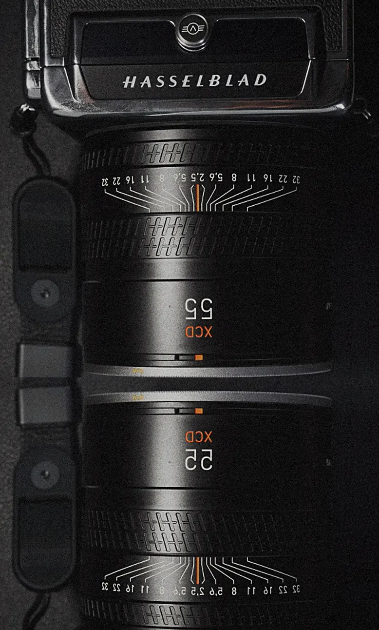 Two Hasselblad XCD 55 lenses mirrored against a dark ground